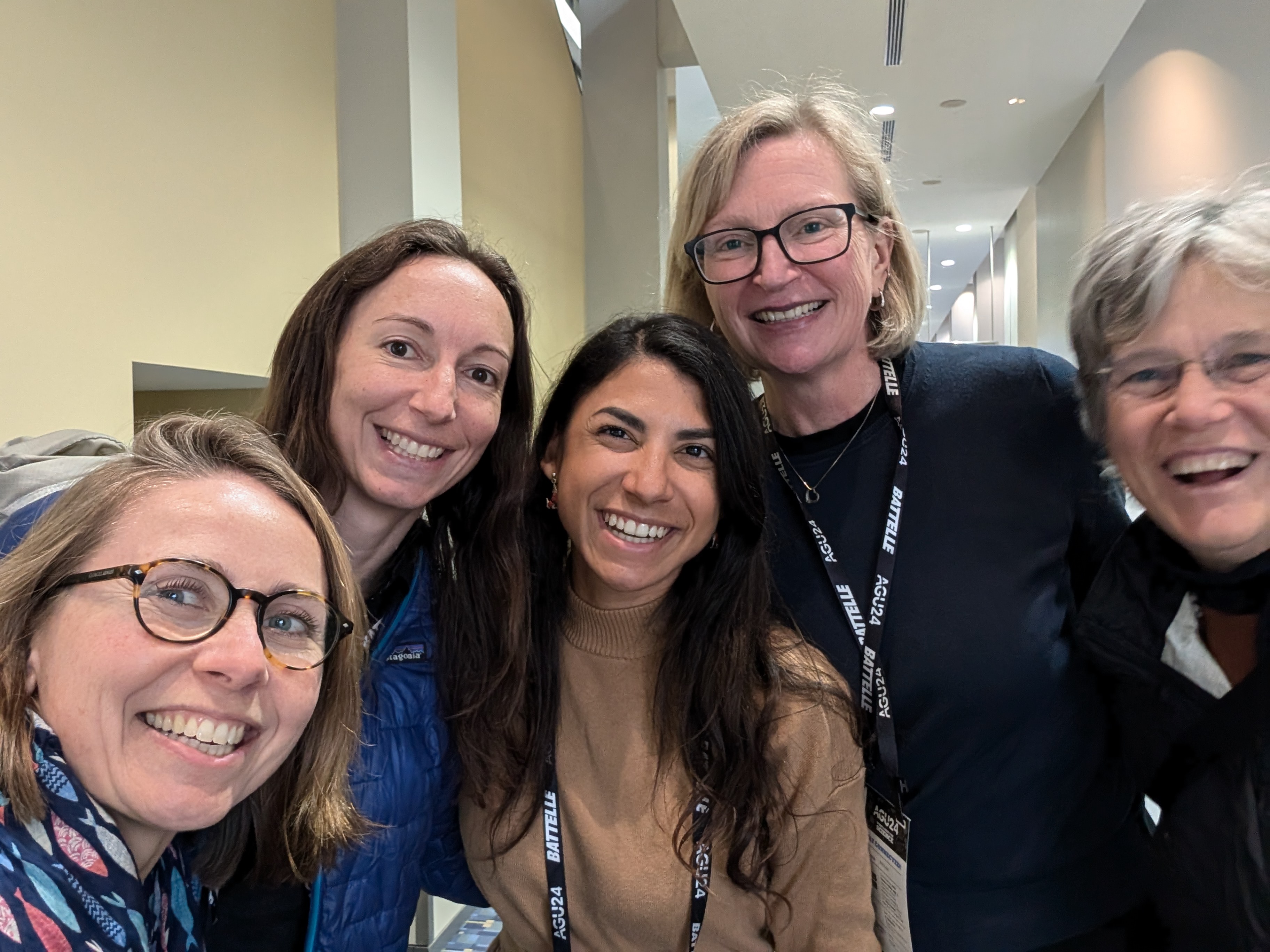 selfie of 5 women, with joy on their faces, each with an arm around the person next to them