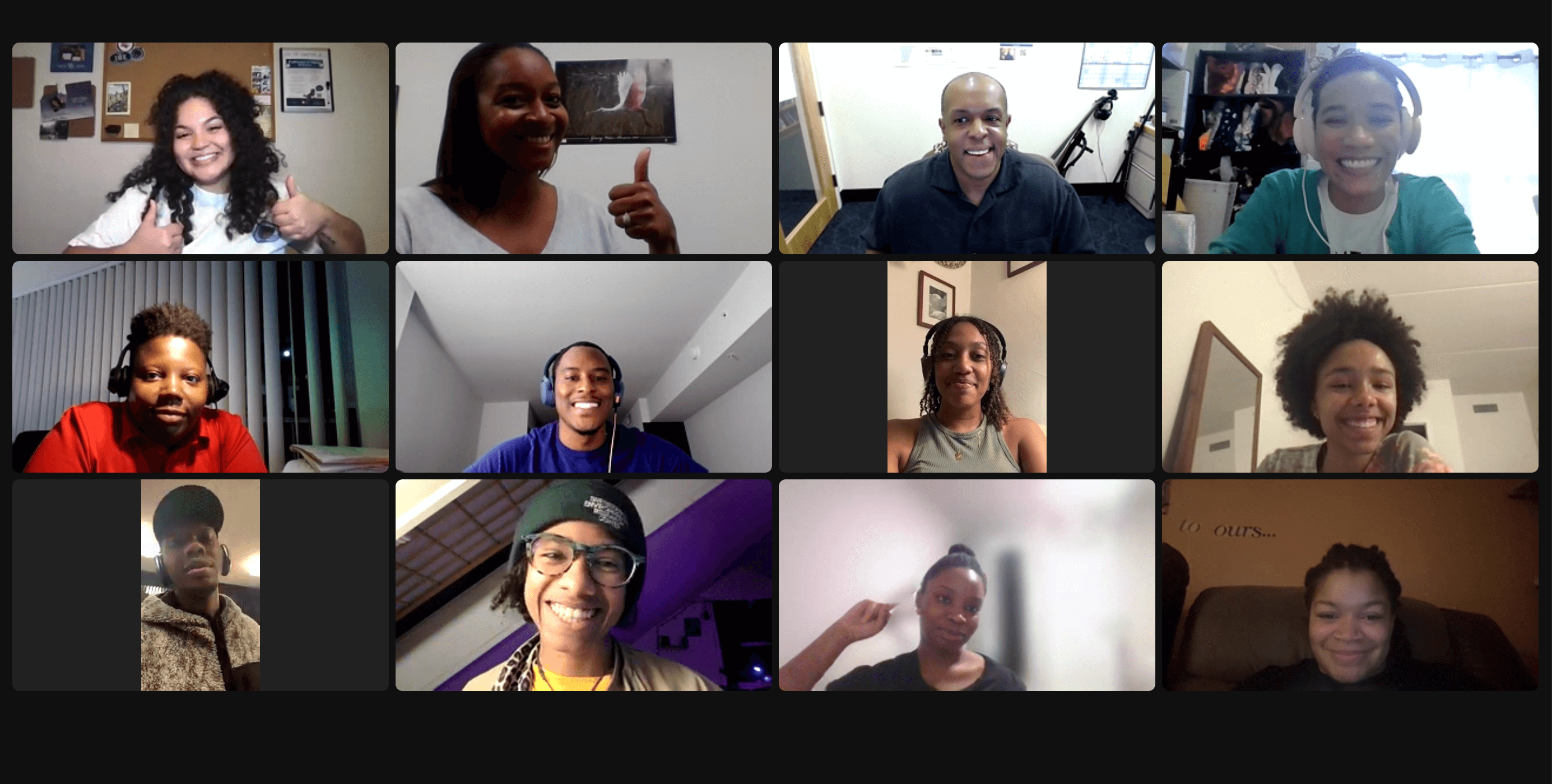 Zoom screenshot of smiling faces of Black people in a 3 by 4 grid. Some are giving thumbs up.